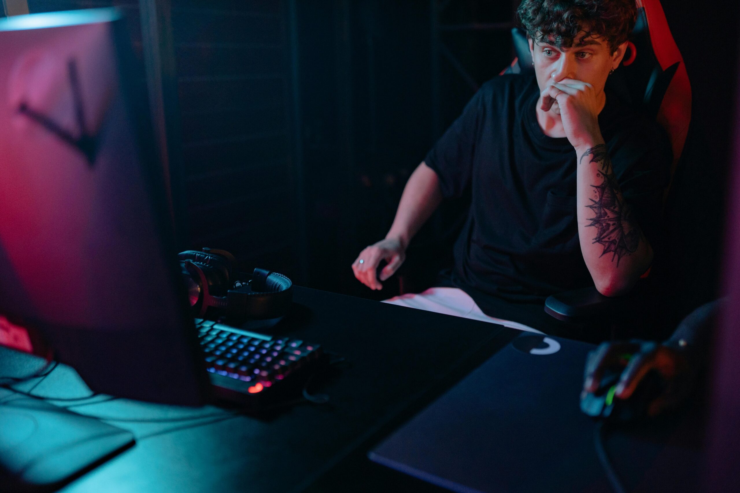 A gamer using a controller and headset focused on long-distance strategy in Apex Legends.