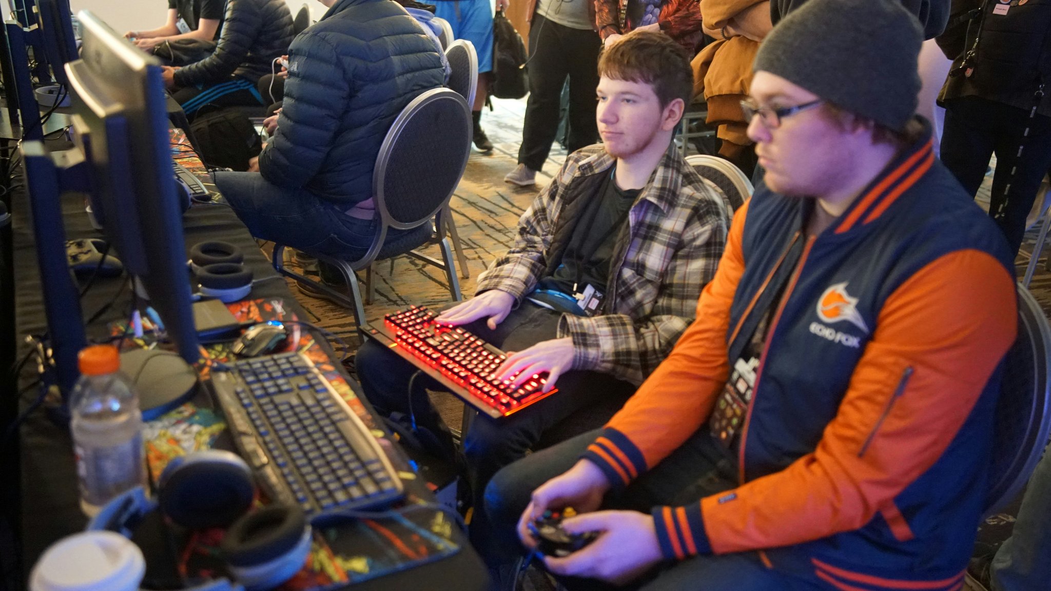 Player crouching behind rocks aiming downward