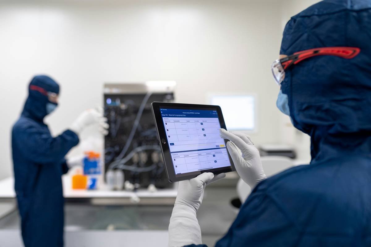Laboratory technicians working with Electronic Batch Recording software in the lab