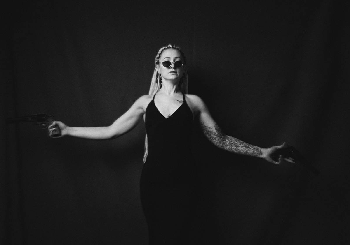 Woman in black dress with arms outstretched