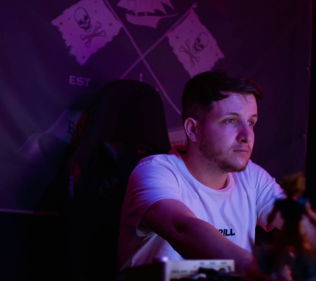 Young man wearing a white t-shirt indoors.